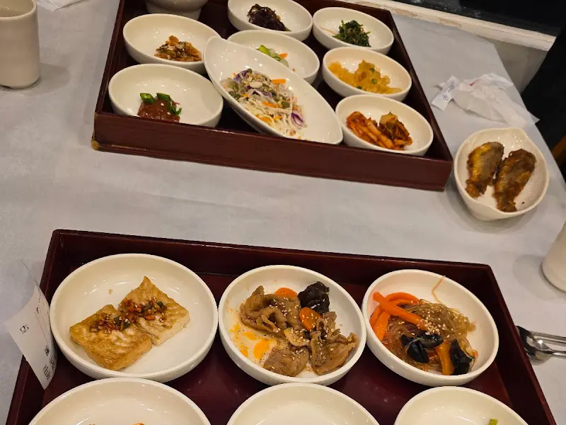 다양한 반찬들이 나무 쟁반 위에 정갈하게 담겨 있는 모습