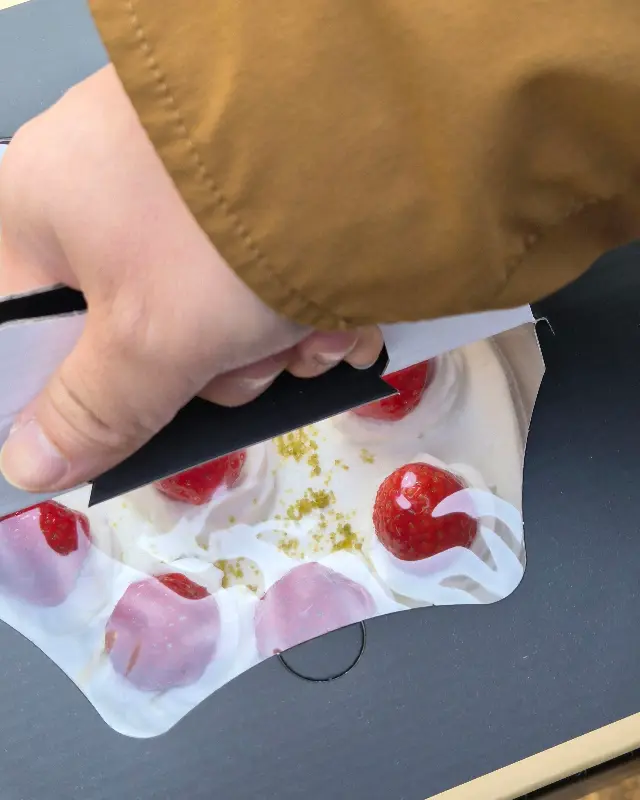 딸기 케이크 포장 상자를 열고 있는 모습