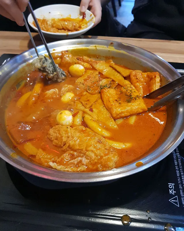 떡볶이를 집어 올리는 모습