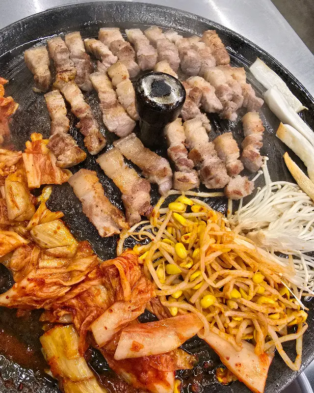 솥뚜껑 위에서 구워지는 삼겹살과 김치의 조화