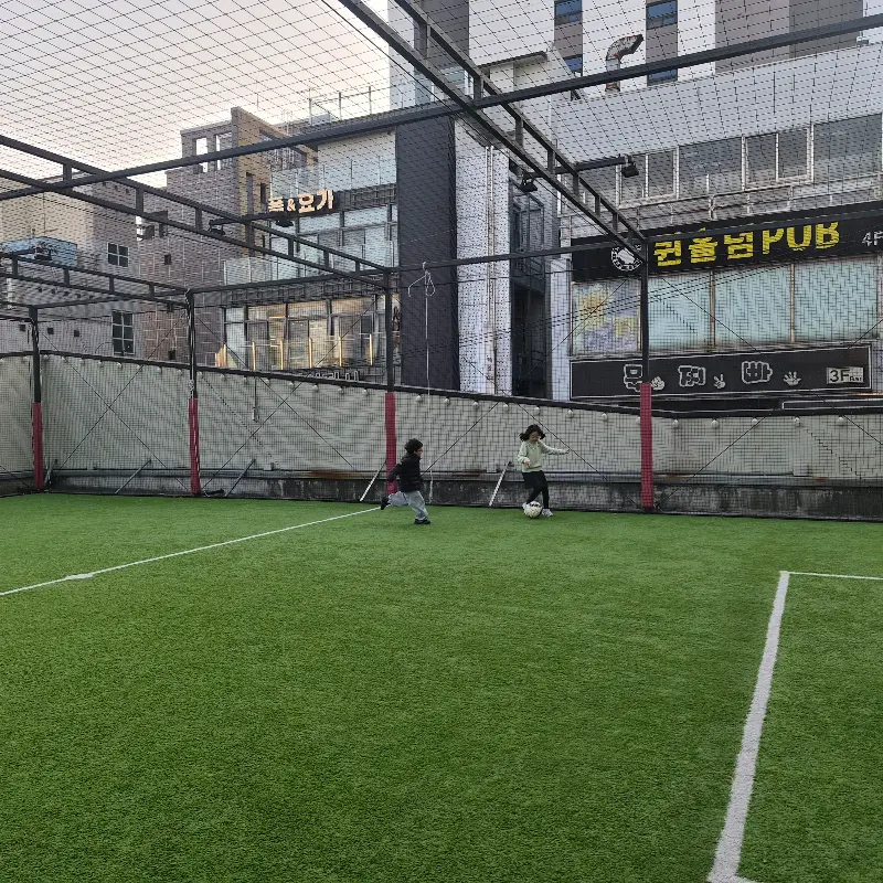 풋살장에서 뛰어노는 아이들