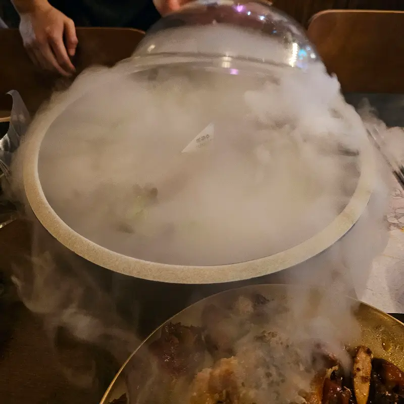 족발과 함께 드라이아이스 연기가 테이블을 가득 채운 모습