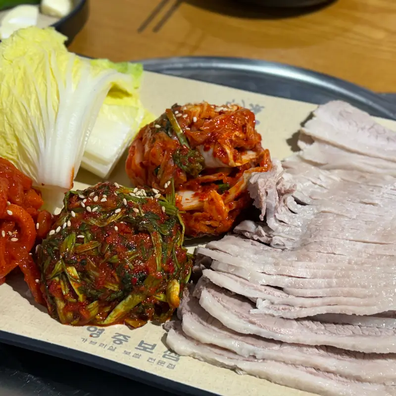 배추에 보쌈과 김치를 얹어놓은 사진