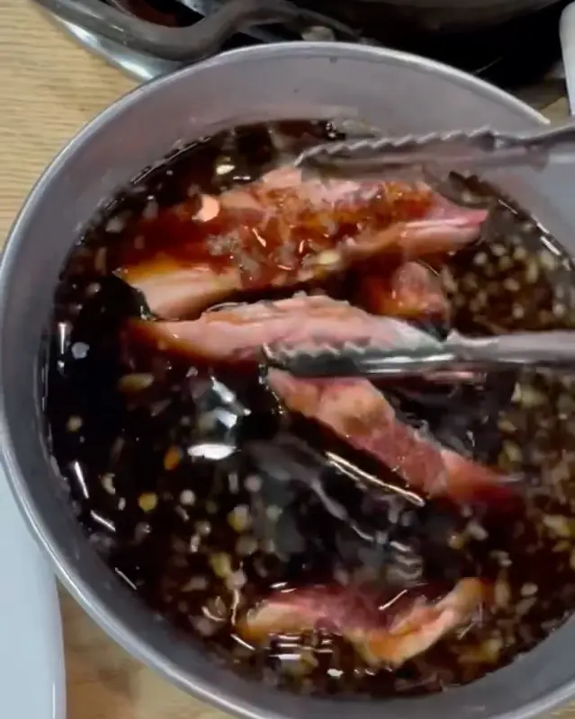 소갈비살을 특제 소스에 찍어 먹는 모습