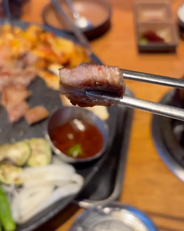 젓가락으로 집은 삼겹살