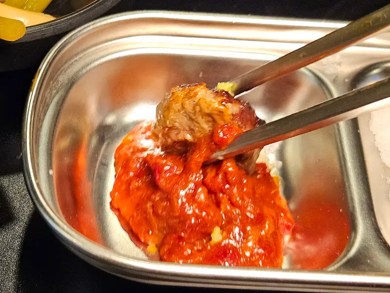 고기를 쌈에 싸서 먹는 모습