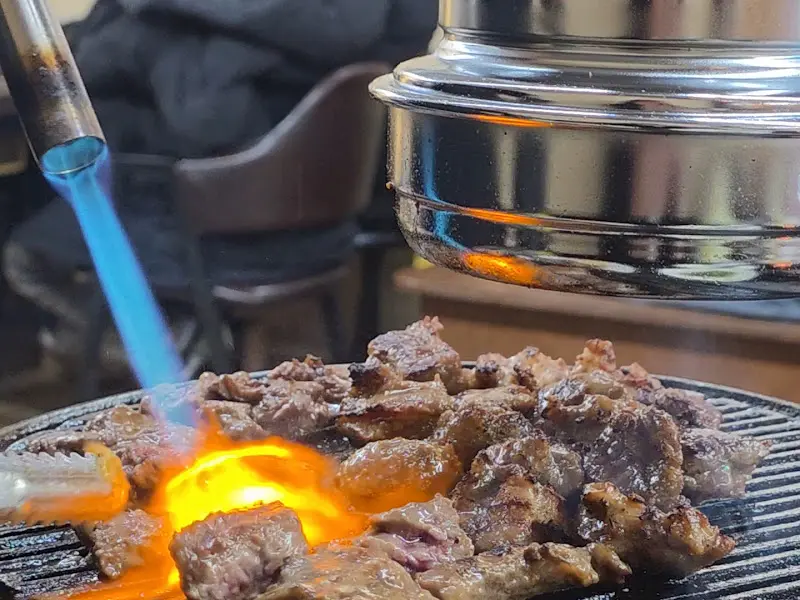 토치로 고기를 직접 구워주는 모습