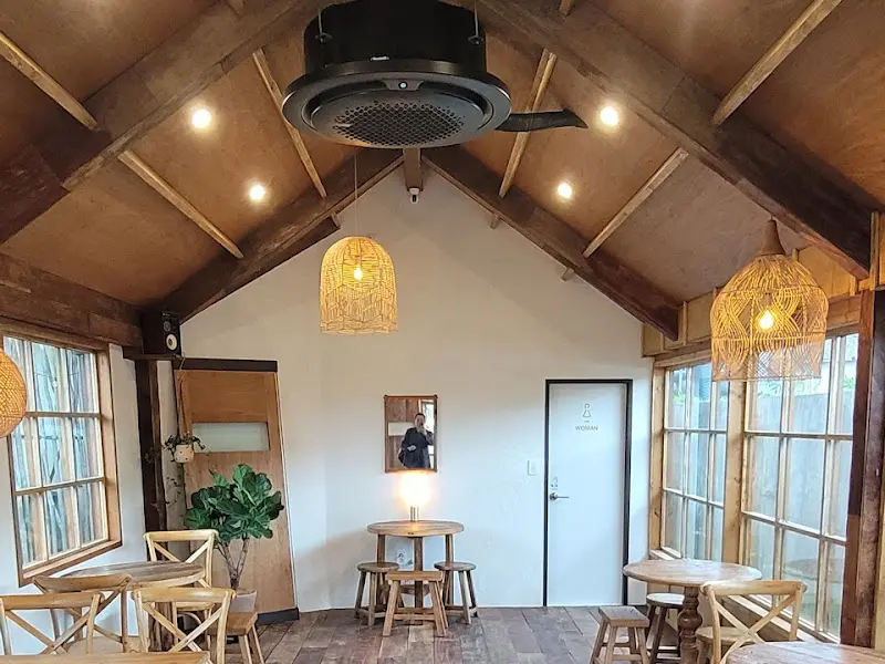 카페 내부 인테리어: 나무로 마감된 천장과 따뜻한 조명이 아늑한 분위기를 연출한다.