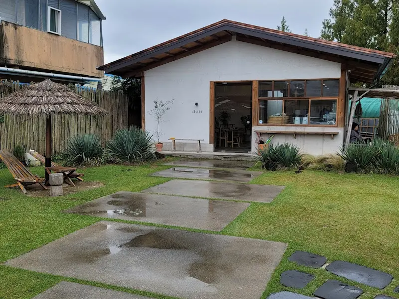 마요르카 카페 외부 전경: 작은 교회당 같은 건물과 넓은 잔디밭이 인상적이다.