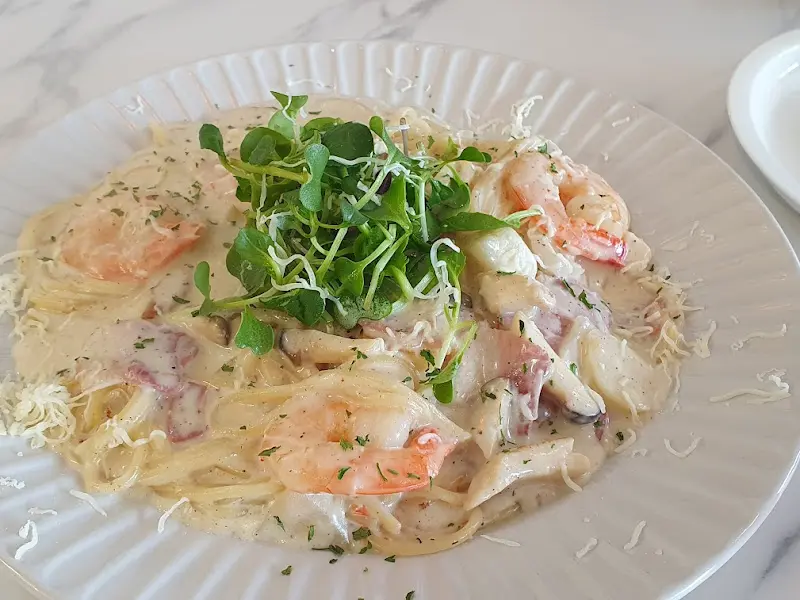 크림 파스타 위에 올려진 새싹 채소