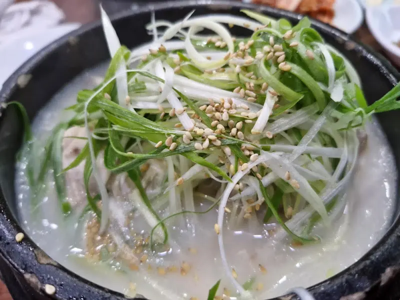 파채와 깨가 듬뿍 올려진 삼계탕의 모습