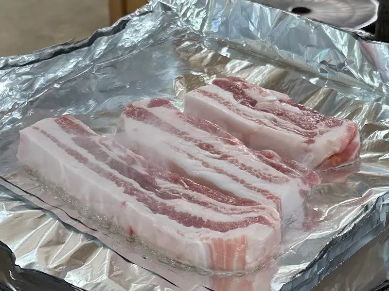 두툼한 삼겹살의 클로즈업 사진. 신선한 고기의 질감이 느껴진다.