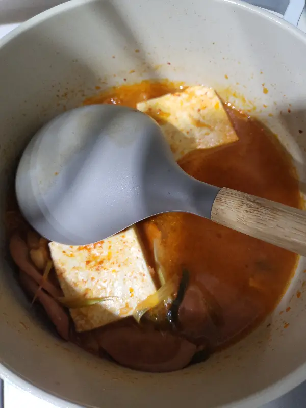 국자로 떠올린 부대찌개의 모습