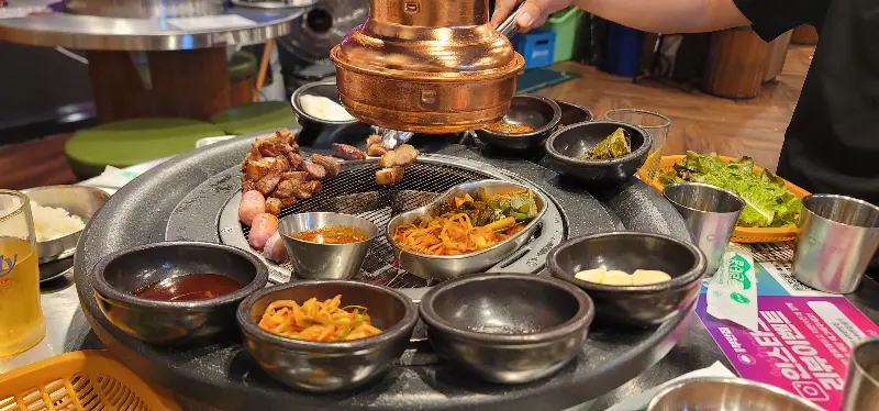 테이블마다 설치된 환풍기와 다양한 곁들임 찬들