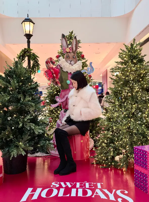 크리스마스 장식 앞에서 포즈를 취한 여성