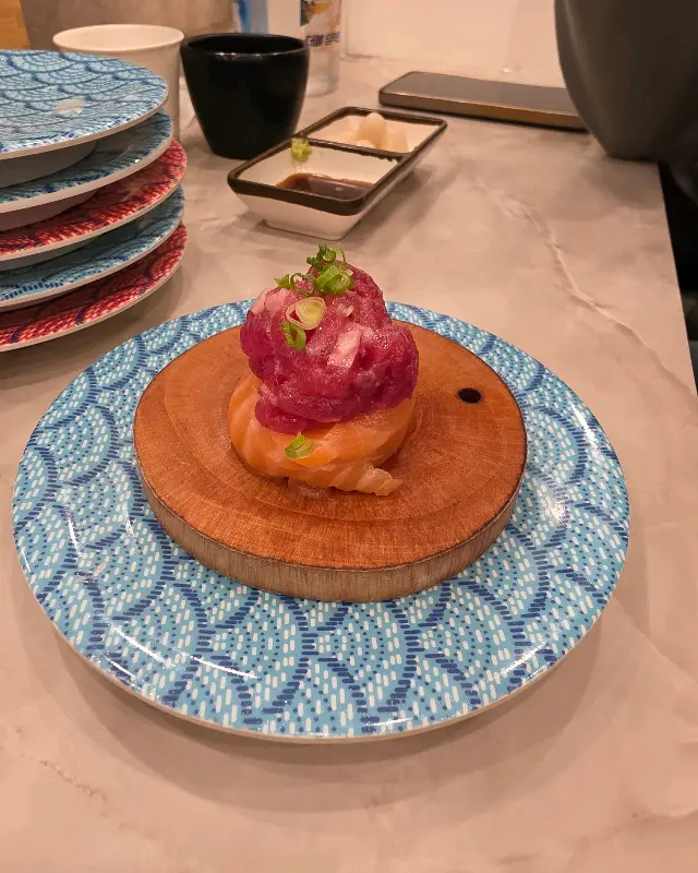 신선한 육회와 연어가 조화롭게 올려진 초밥의 모습