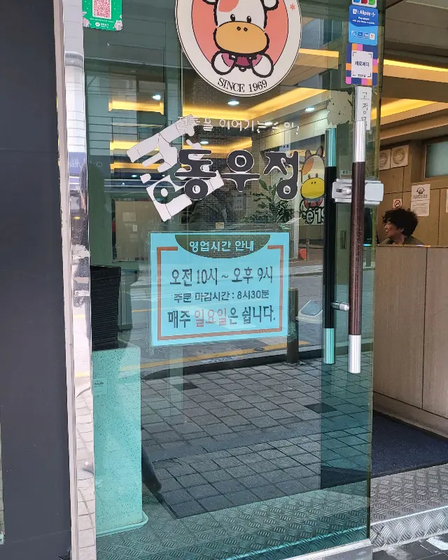 가게 유리문에 붙어있는 영업시간 안내