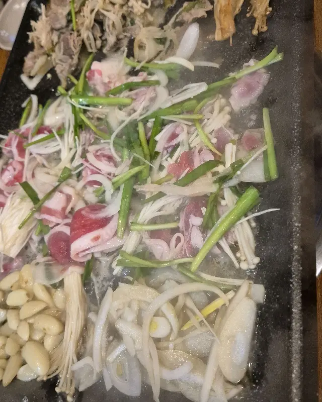 철판 위에서 익어가는 오리고기와 채소들