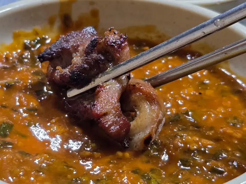 잘 구워진 뽈살을 소스에 찍어먹는 모습