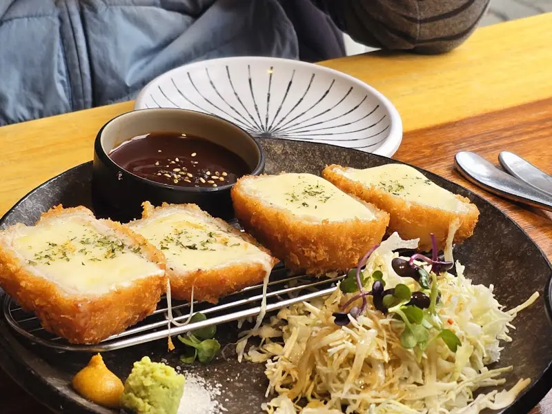 테이블 위에 놓인 소고기 치즈 카츠 정식