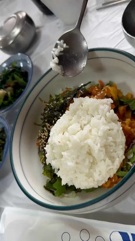 멍게 비빔밥에 밥을 넣는 모습