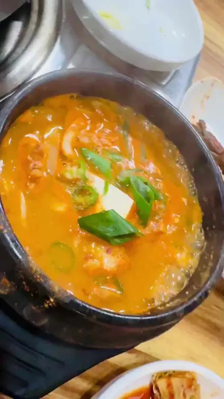 뚝배기에 담긴 김치찌개의 모습이 클로즈업 되어 있다.