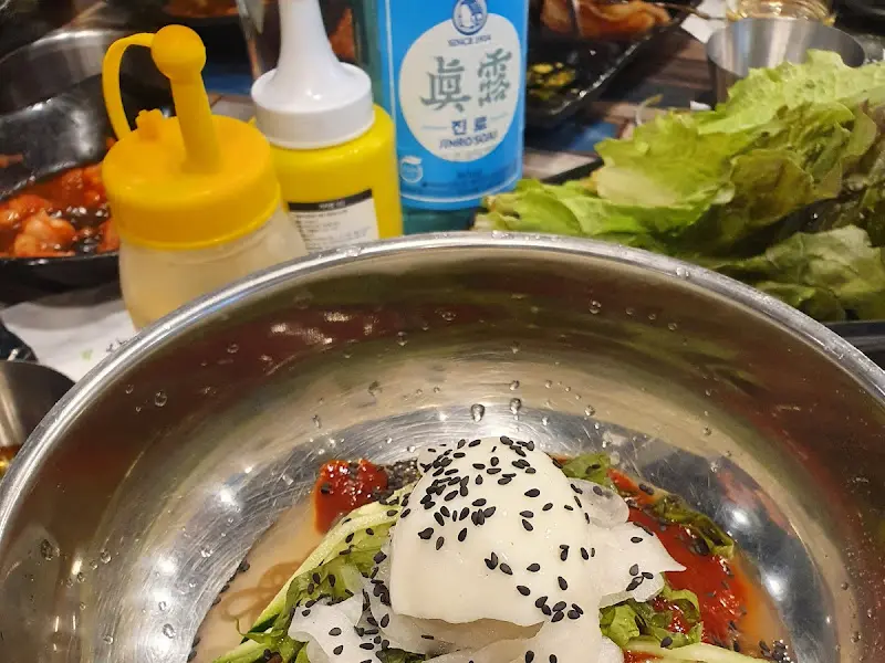 시원한 물냉면 위에 깨가 듬뿍 뿌려진 모습