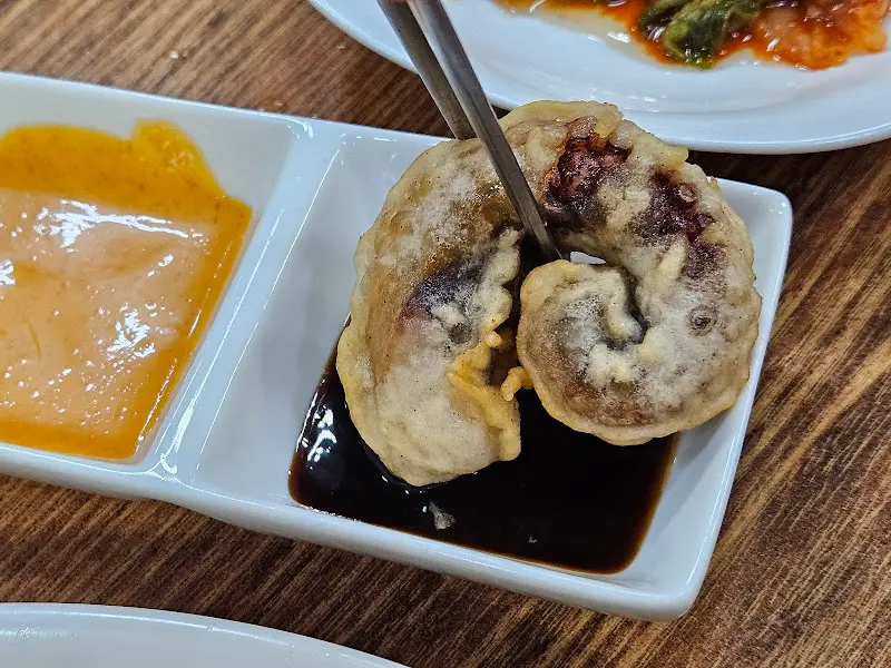 문어 튀김을 소스에 찍어 먹는 모습