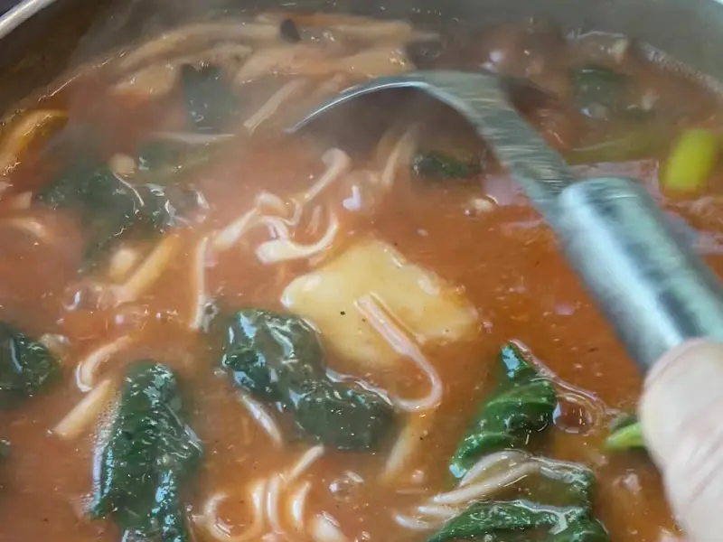 국자로 어죽을 뜨는 모습