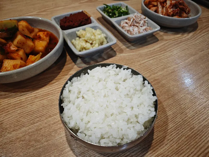 밥 한 공기와 깍두기, 다진 마늘 등이 놓여 있는 모습