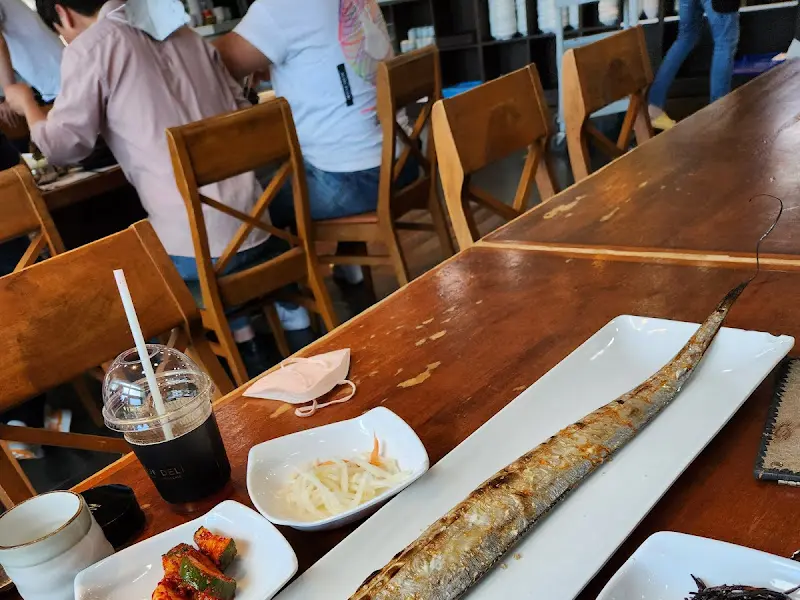 테이블 위에 놓인 갈치구이와 밑반찬