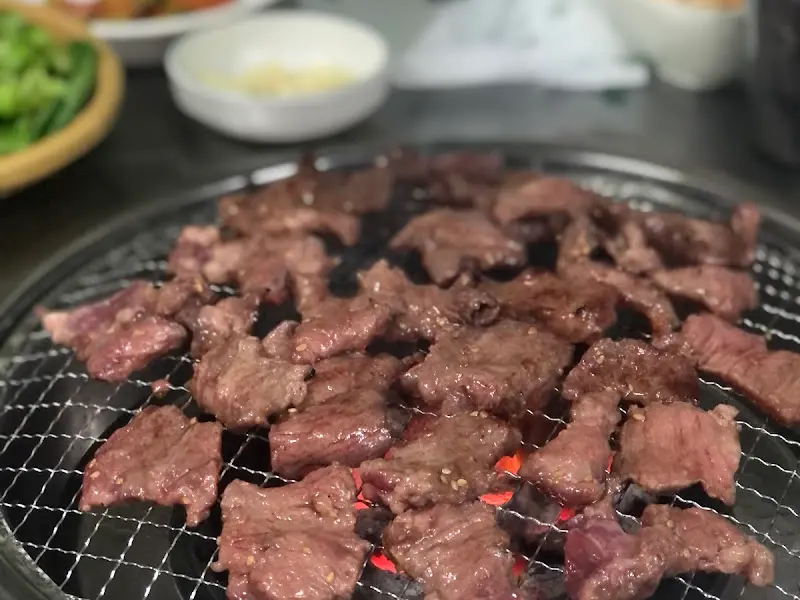 불판 위에서 익어가는 갈매기살의 클로즈업 사진