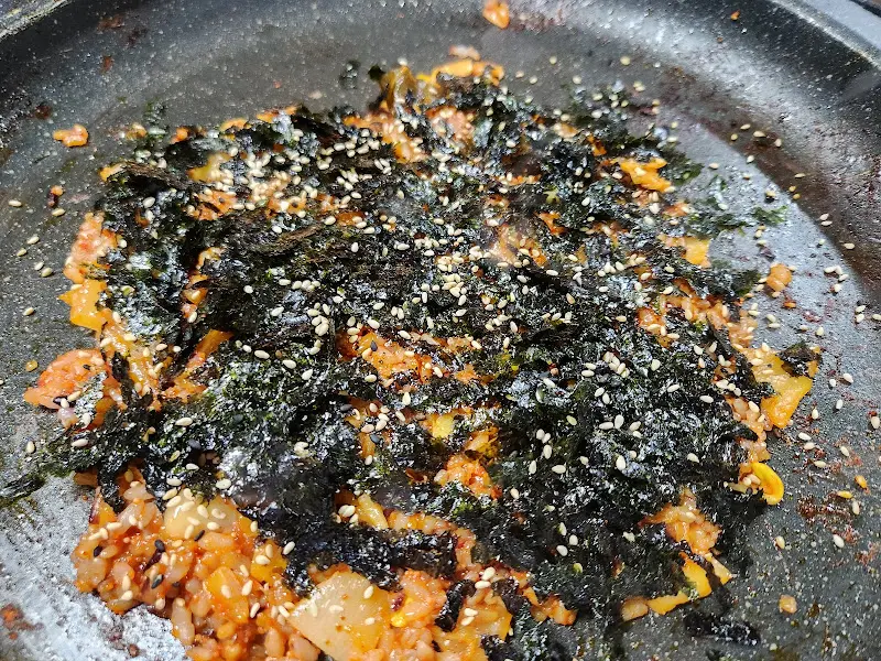 해물 삼합 볶음밥 위에 김가루가 듬뿍 뿌려진 모습