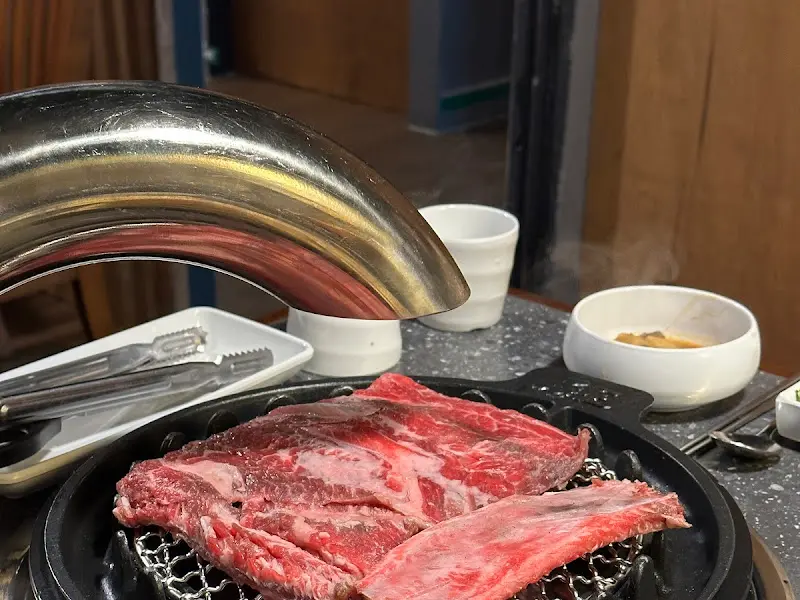 불판 위에 올려진 생갈비 조각