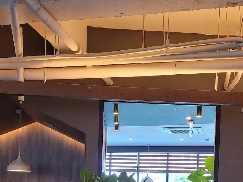 천장에 노출된 배관과 조명이 보이는 인테리어