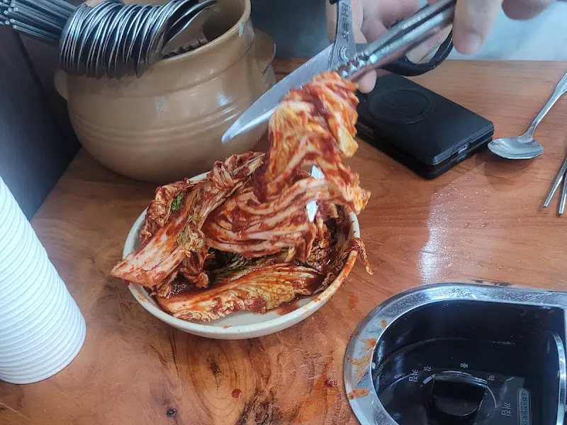 테이블에 놓인 김치를 자르는 모습