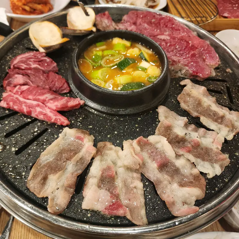 불판 위에서 익어가는 소고기와 된장찌개