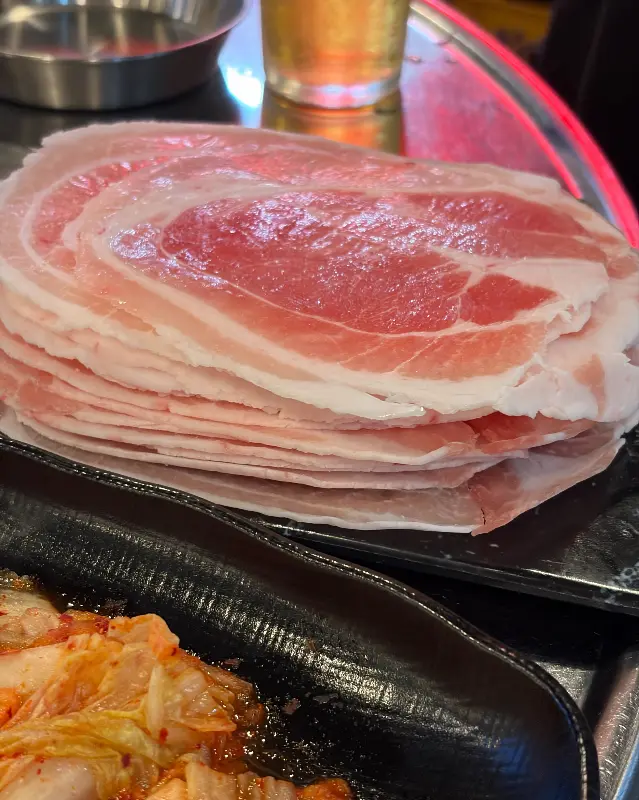 불판 위에서 맛있게 구워지고 있는 냉삼겹살