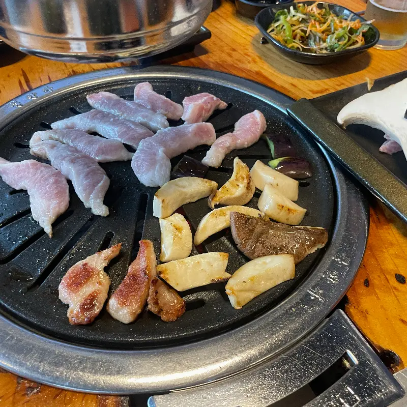 불판 위에서 익어가는 항정살과 버섯