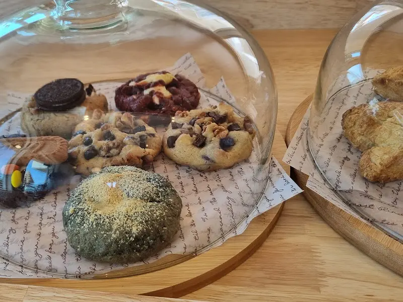 유리 덮개 아래 가지런히 놓인 다양한 종류의 수제 쿠키