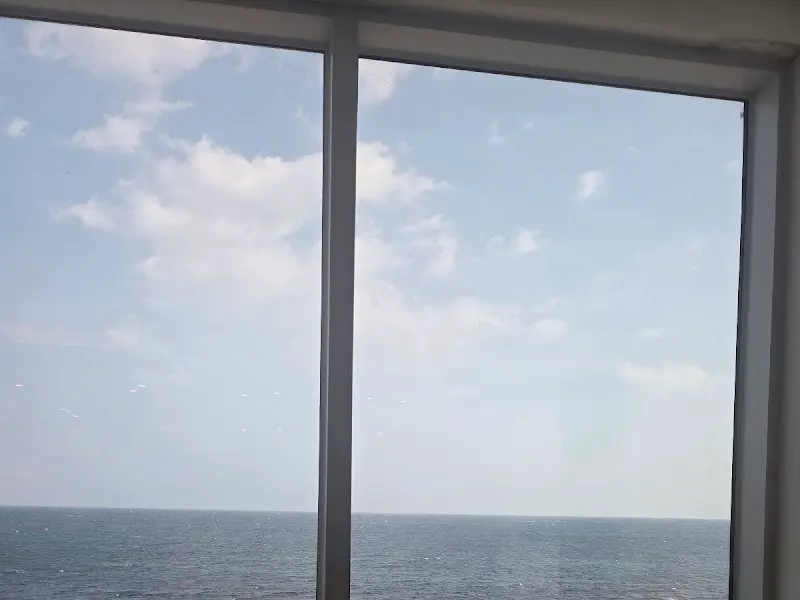 카페 창문 너머로 보이는 푸른 하늘과 바다