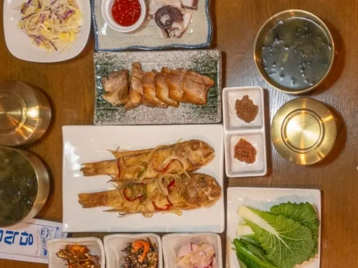 먹음직스러운 수육 한 점과 쌈 채소