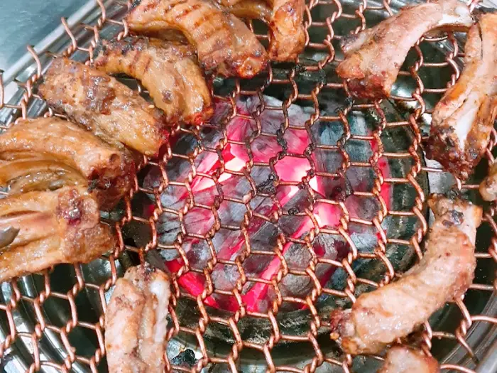 불이 타오르는 숯불과 그 위에서 익어가는 등갈비