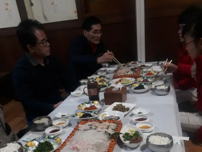 여러 테이블에 사람들이 앉아 식사하는 모습