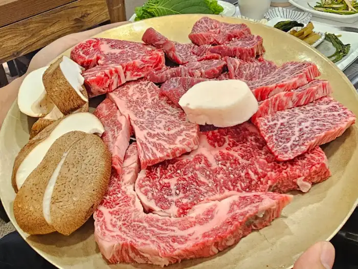 한 접시에 담긴 다양한 소고기 부위와 버섯