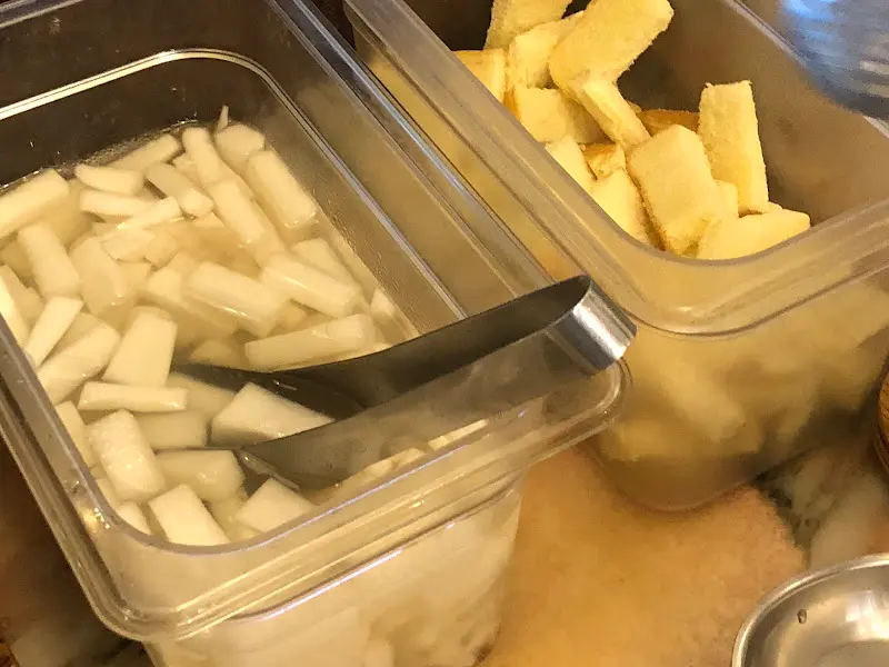 셀프바에서 단무지와 피클을 가져가는 모습