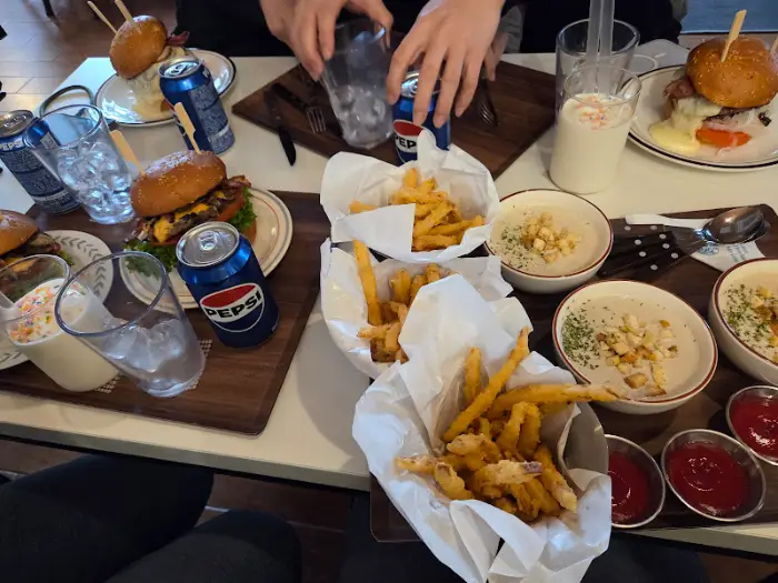 테이블에 놓인 다양한 버거와 사이드 메뉴