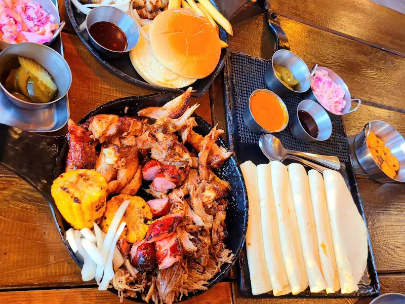 다양한 소스와 곁들임 메뉴가 함께 제공되는 바베큐 플래터