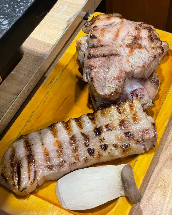 노릇하게 구워진 통삼겹살과 버섯