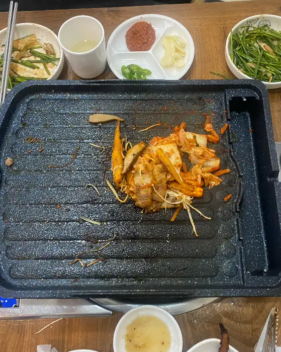 식탁 위에 놓인 쌈 채소와 김치, 쌈장 등